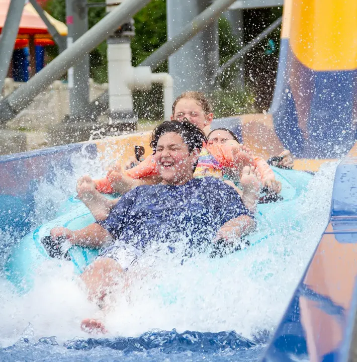 Family going down slide at Mansfield park location