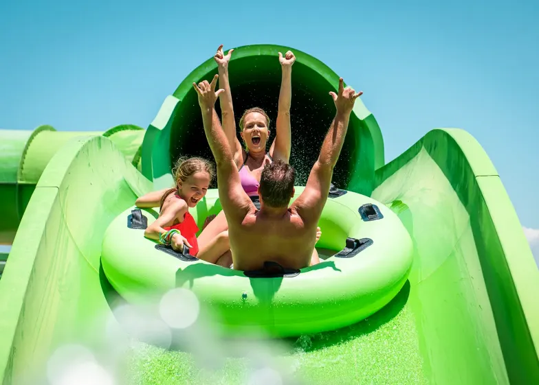Family going down slide at Hawaiian Falls